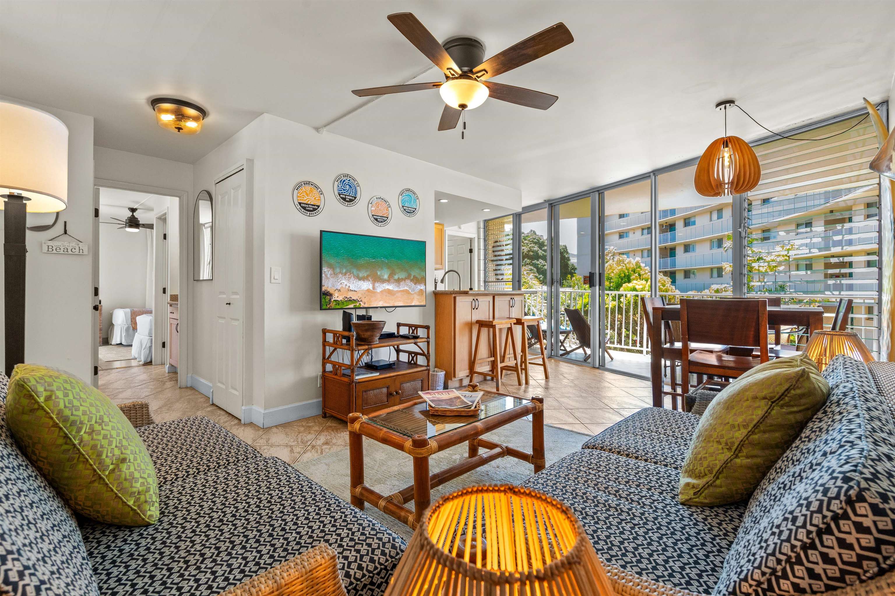 2450 South Kihei Road, Unit 301 Kihei, HI 96753 - Photo 9 of 35 a living room with furniture a rug and a large window