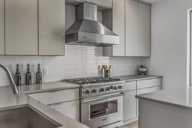 a kitchen with granite countertop a stove and a sink