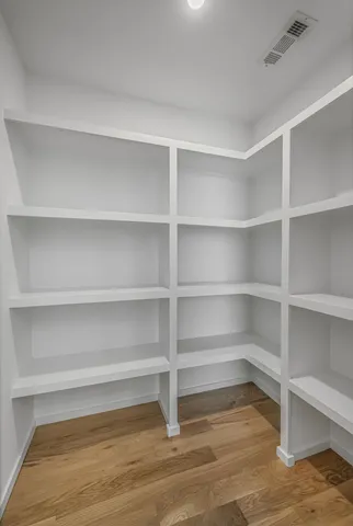 a view of walk in closet with empty racks