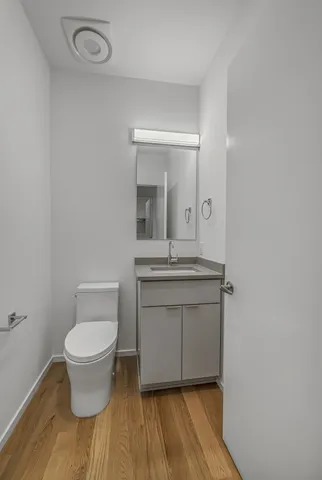 a bathroom with a toilet sink and a mirror