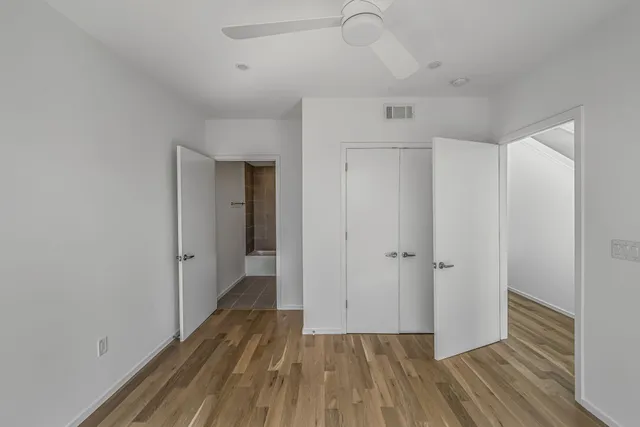 a view of hallway with wooden floor
