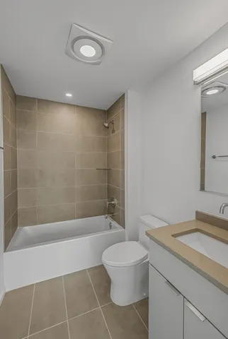 a bathroom with a bathtub a toilet a sink and shower