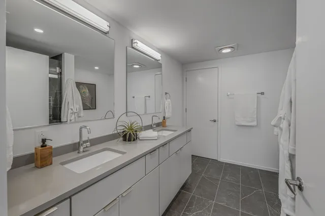 a bathroom with a double vanity sink and a mirror