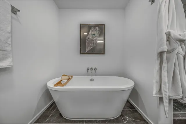 a white bath tub sitting in a bathroom