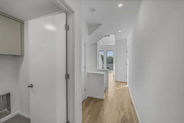 a view of a room with wooden floor sink and bathroom