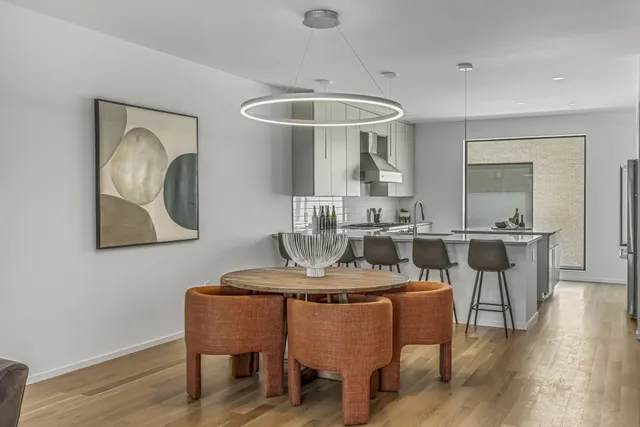 a view of a dining room with furniture wooden floor and chandelier