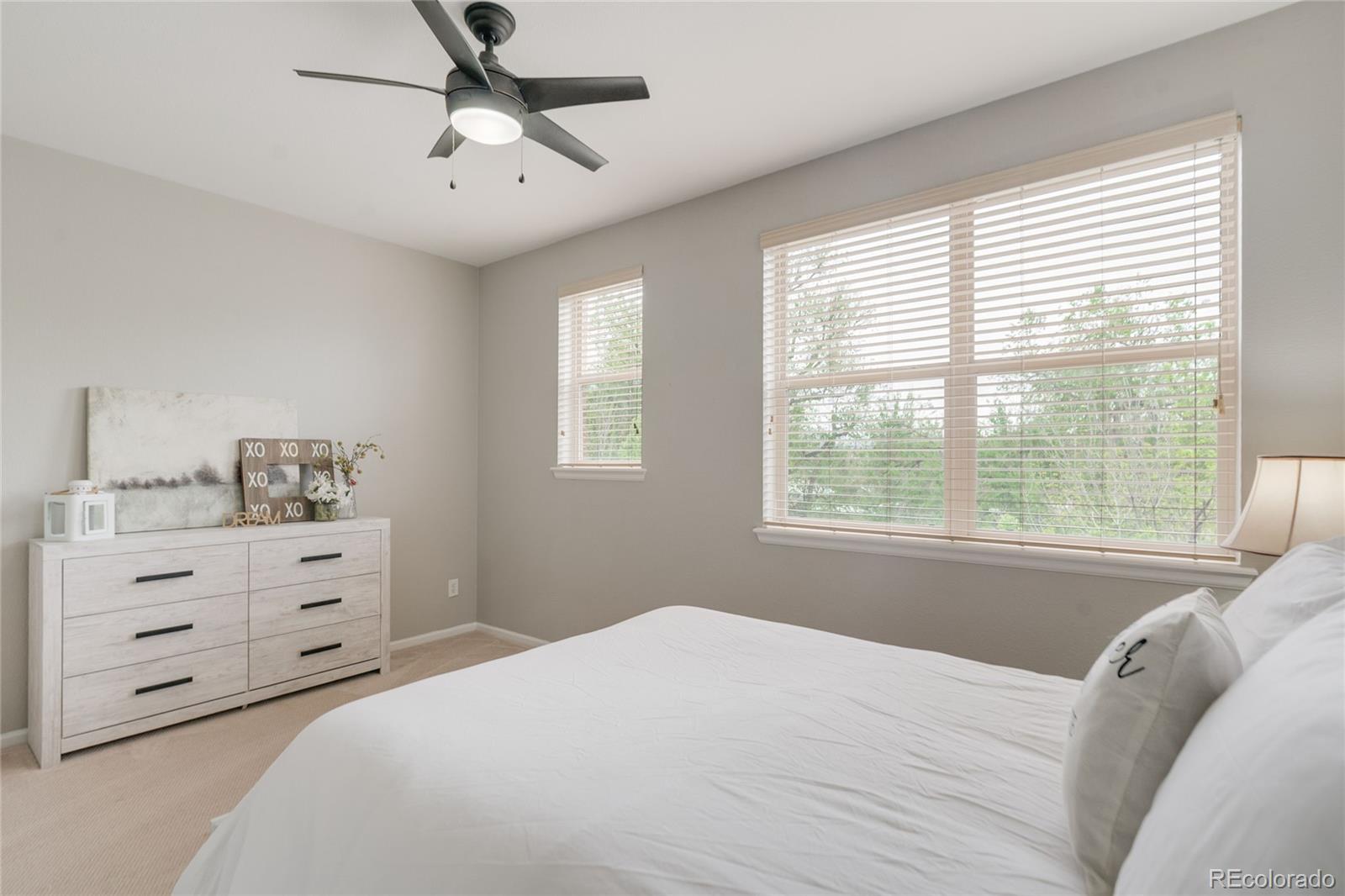 5392 Allison Street Arvada, CO 80002 - Photo 17 of 47 a bedroom with a bed and a window dresser