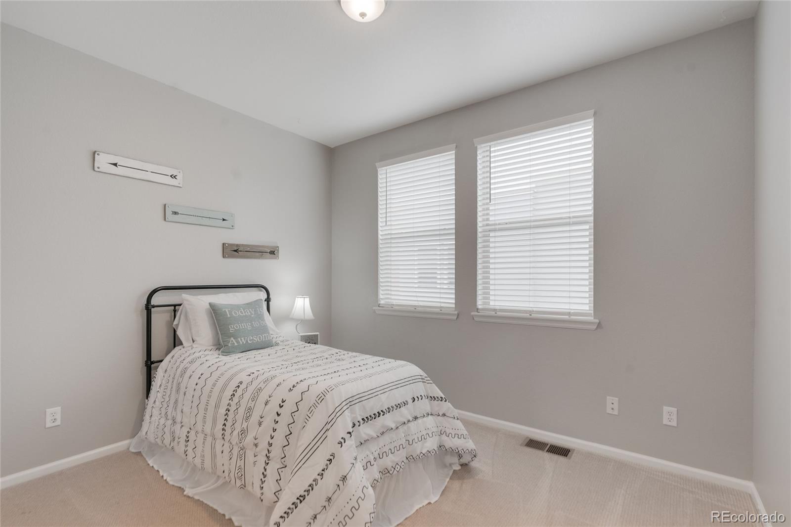 5392 Allison Street Arvada, CO 80002 - Photo 21 of 47 a bedroom with a bed and a window
