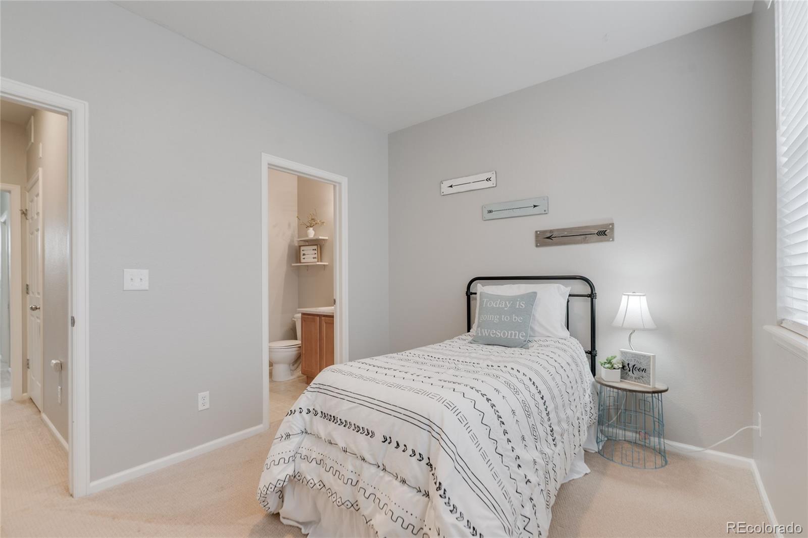 5392 Allison Street Arvada, CO 80002 - Photo 22 of 47 a bedroom with a bed and a mirror