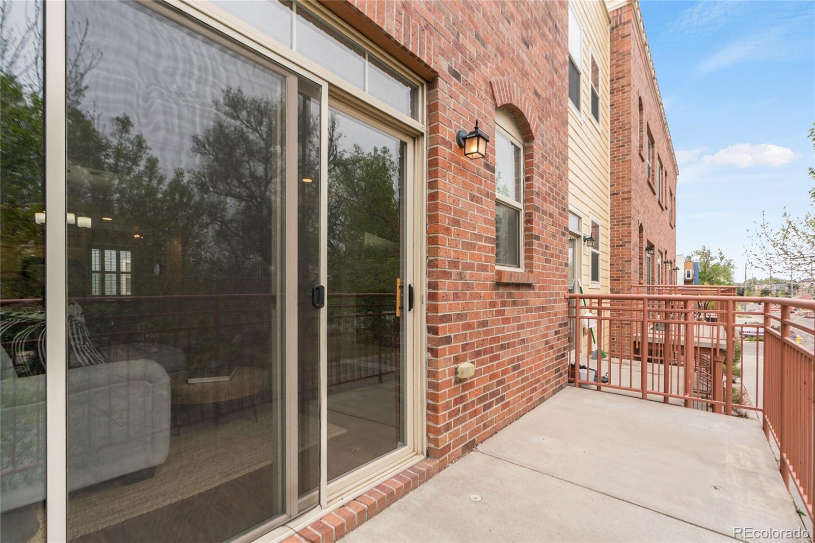 5392 Allison Street Arvada, CO 80002 - Photo 30 of 47 a balcony with a glass door