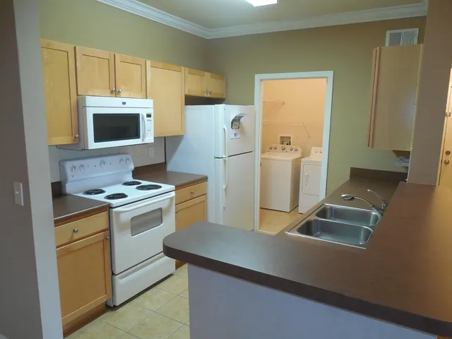 a kitchen with a stove and a refrigerator
