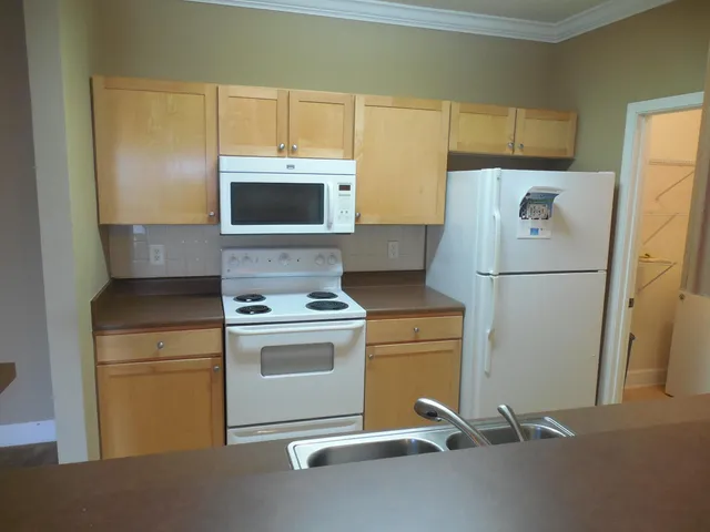 a kitchen with a refrigerator stove and microwave