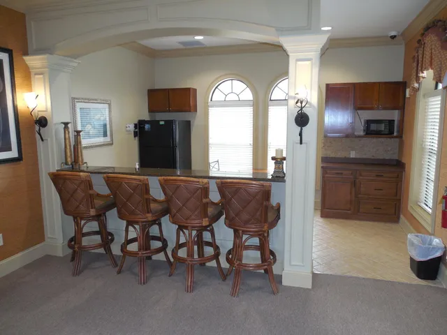a view of a dining room with furniture and a large window