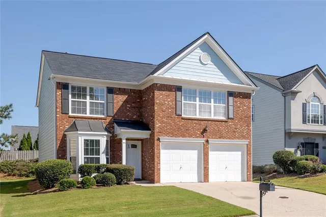 a front view of a house with a yard