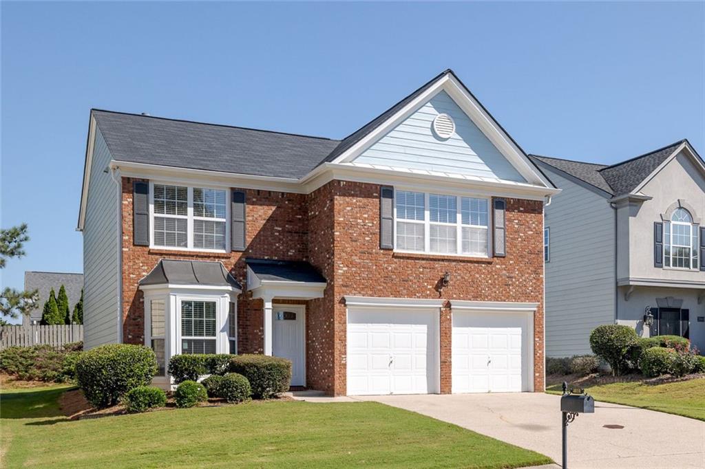 4010 Ridgefair Drive Cumming, GA 30040 - Photo 1 of 28 a front view of a house with a yard