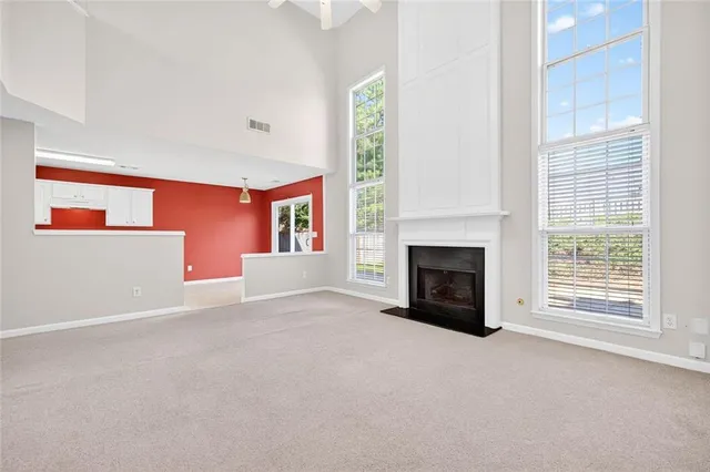 a view of a livingroom with a fireplace and a window