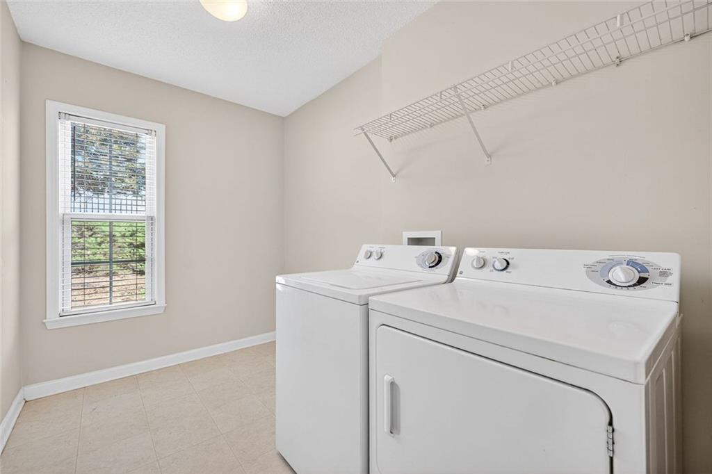 4010 Ridgefair Drive Cumming, GA 30040 - Photo 17 of 28 a utility room with dryer and washer