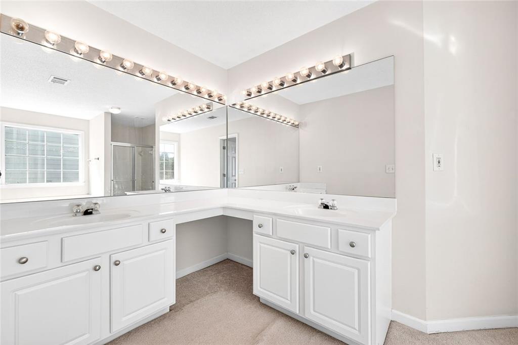 4010 Ridgefair Drive Cumming, GA 30040 - Photo 20 of 28 a view of a double vanity sink a mirror and a window