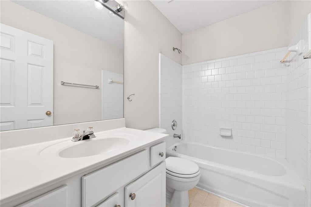 4010 Ridgefair Drive Cumming, GA 30040 - Photo 24 of 28 a bathroom with a sink a toilet and a bathtub