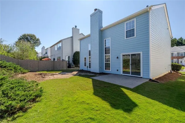 a view of a house with swimming pool and a yard