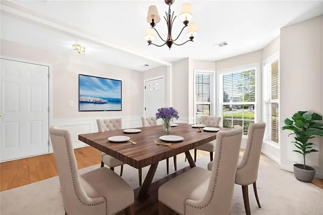 a view of a dining room with furniture window and wooden floor