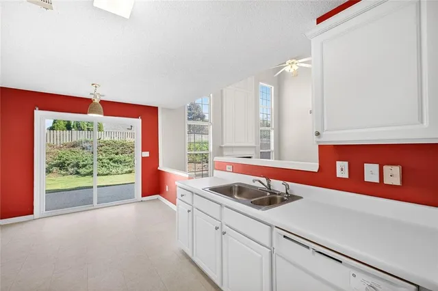 a kitchen with stainless steel appliances a sink and a large window