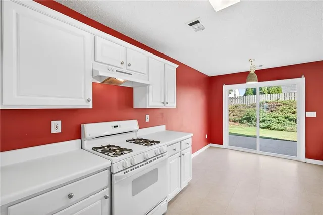 a kitchen with a stove a sink and a microwave