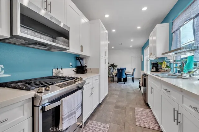 a kitchen with stainless steel appliances granite countertop a stove and a sink