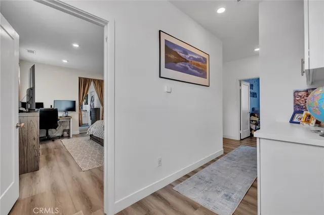 a view of a hallway with workspace and a window