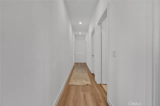a bathroom with a double vanity sink and mirror with toilet