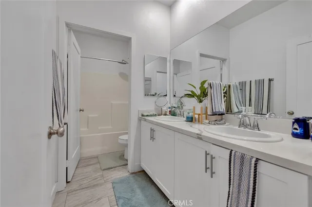 a white bath tub sitting next to a white toilet and sink