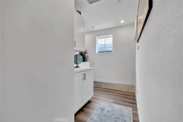 a view of entryway and hall with wooden floor