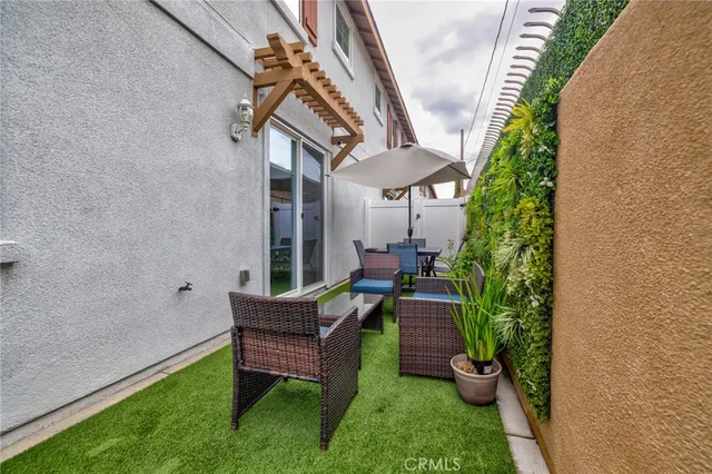 a backyard of a house with table and chairs