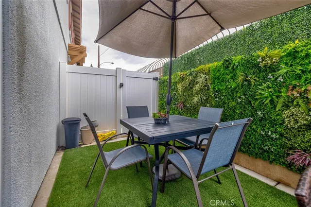 a backyard of a house with table and chairs