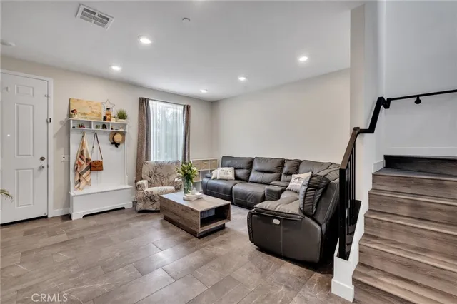 a living room with furniture and white walls