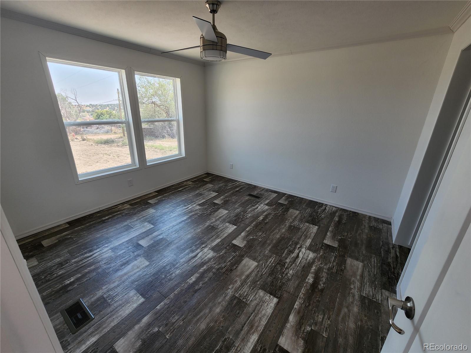 207 Willow Street Rockvale, CO 81244 - Photo 11 of 19 a view of an empty room and window
