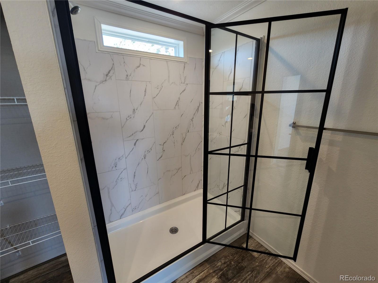 207 Willow Street Rockvale, CO 81244 - Photo 12 of 19 a bathroom with a glass shower door