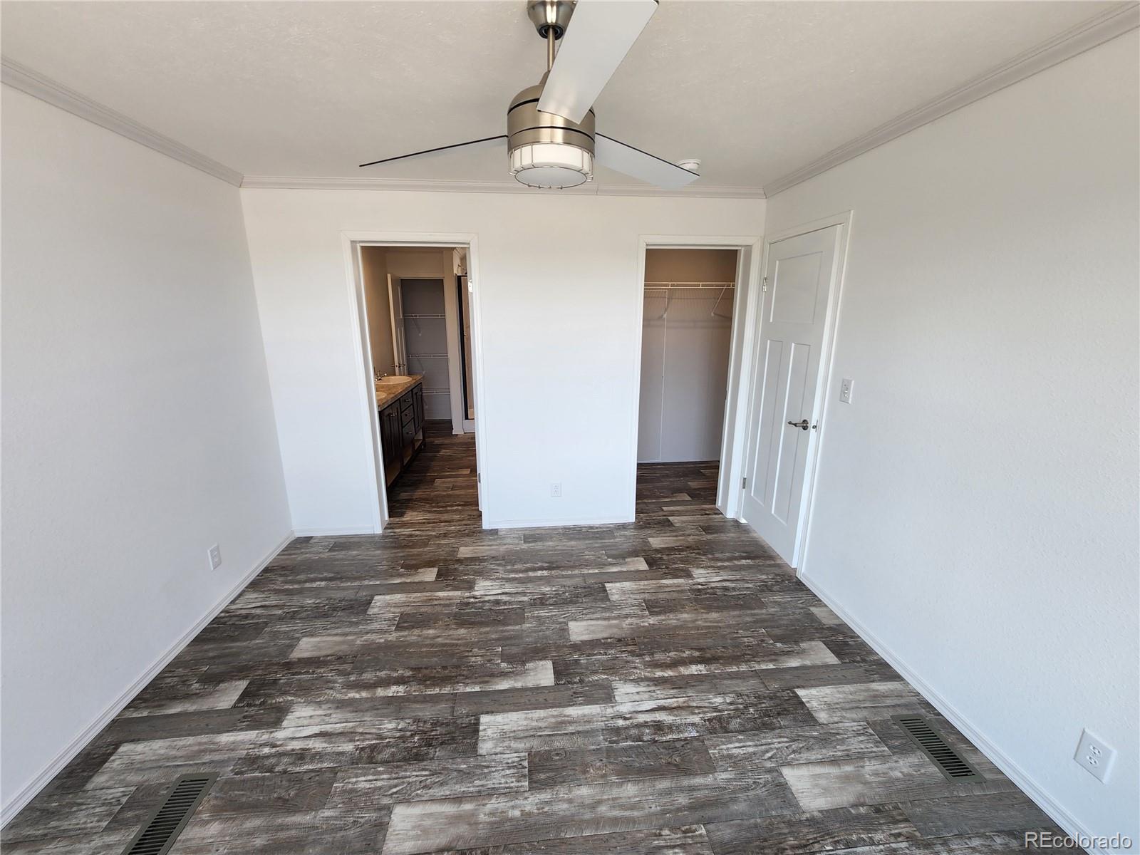 207 Willow Street Rockvale, CO 81244 - Photo 14 of 19 a view of a livingroom with wooden floor and a ceiling fan