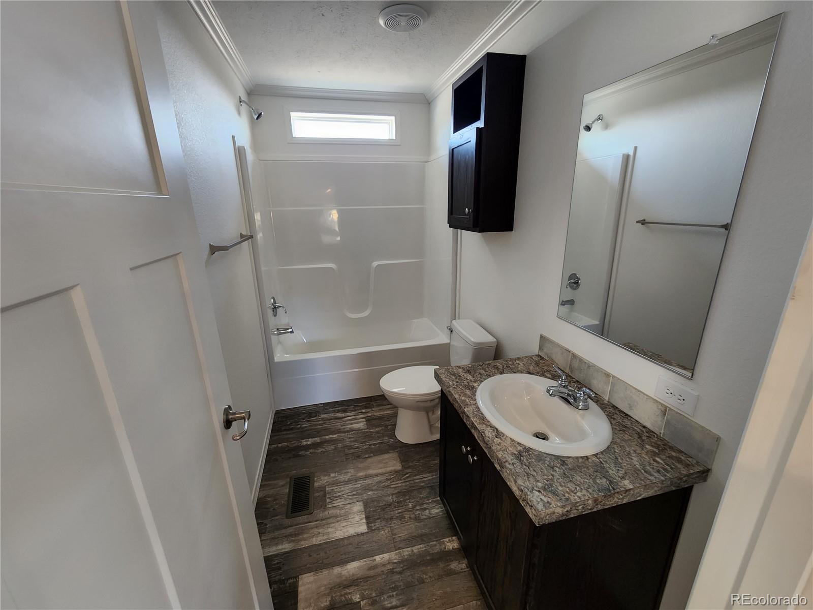 207 Willow Street Rockvale, CO 81244 - Photo 15 of 19 a bathroom with a granite countertop sink toilet and shower