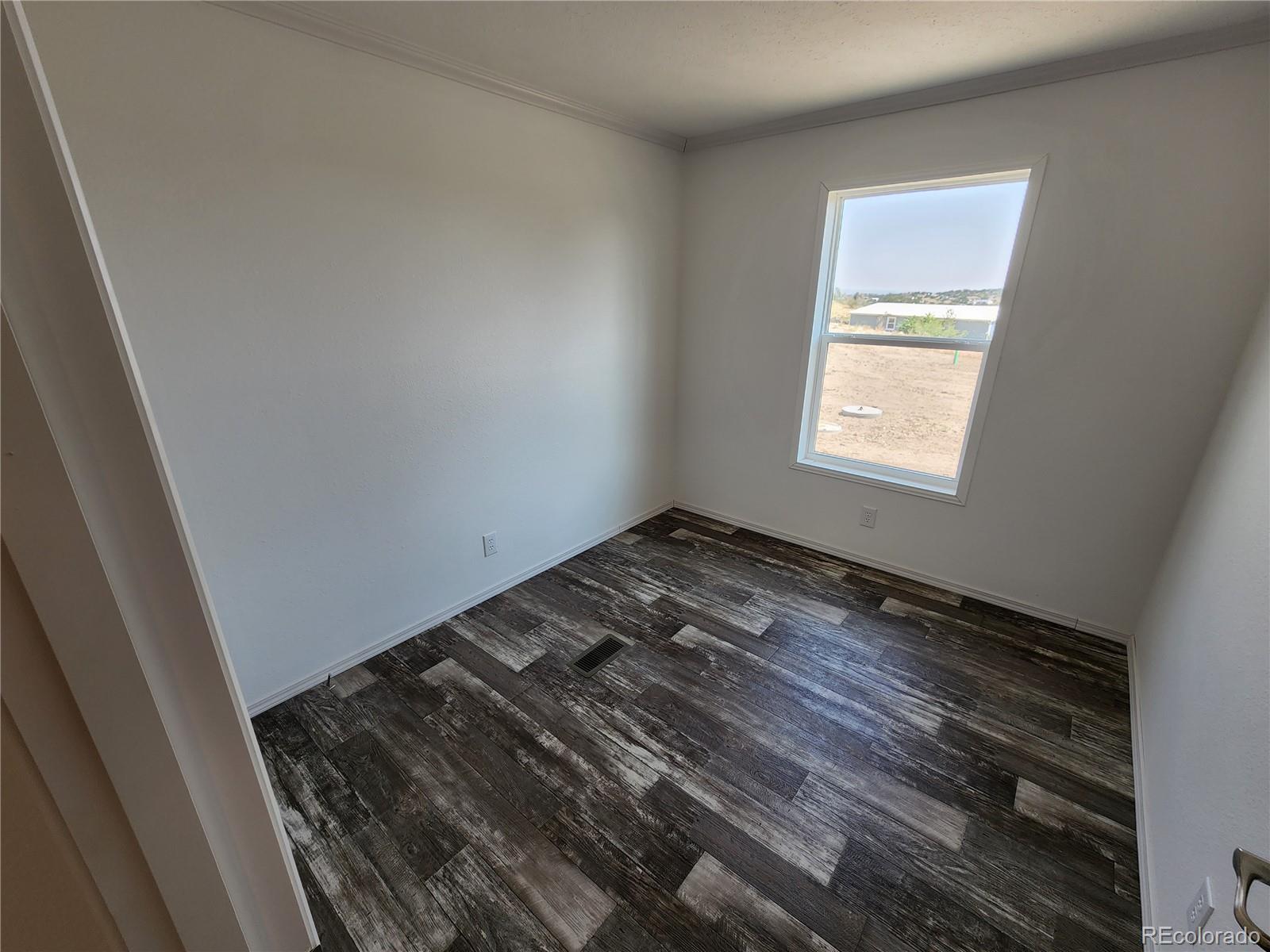 207 Willow Street Rockvale, CO 81244 - Photo 16 of 19 a view of a room that has a bed