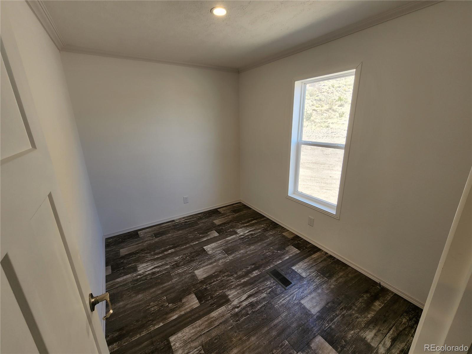 207 Willow Street Rockvale, CO 81244 - Photo 18 of 19 a view of an empty room and window
