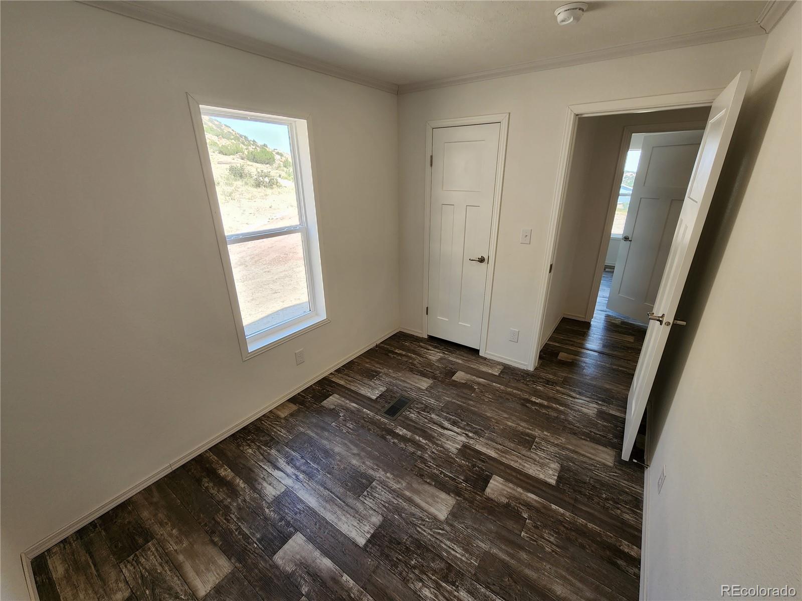 207 Willow Street Rockvale, CO 81244 - Photo 19 of 19 a view of an empty room and wooden floor