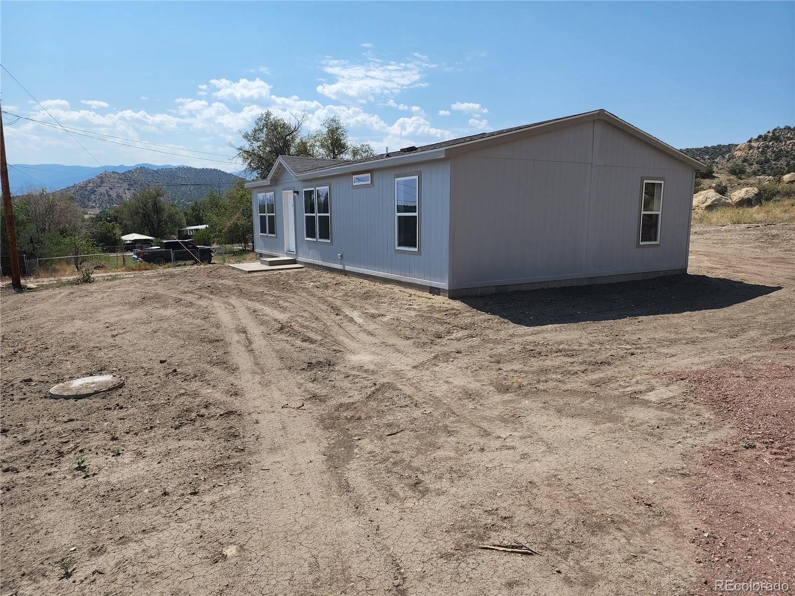 207 Willow Street Rockvale, CO 81244 - Photo 2 of 19 a house view with a backyard space