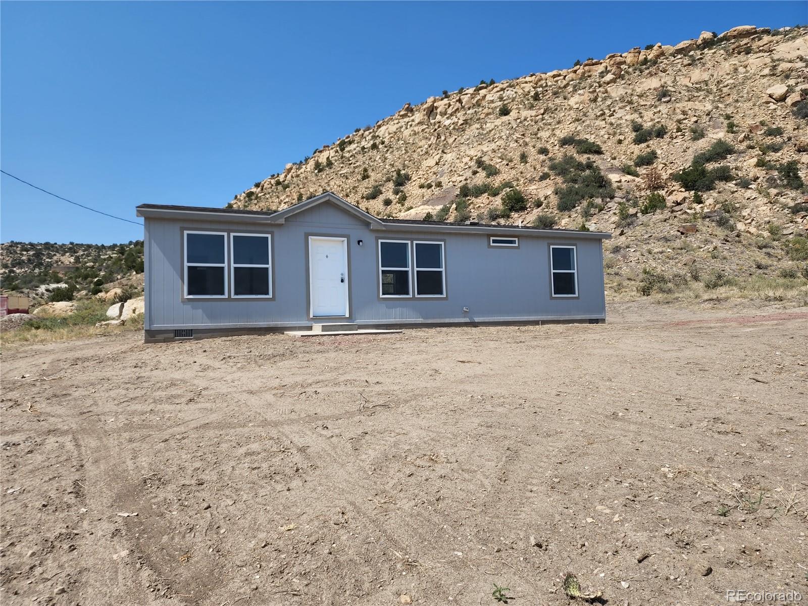 207 Willow Street Rockvale, CO 81244 - Photo 3 of 19 a view of a house with a yard