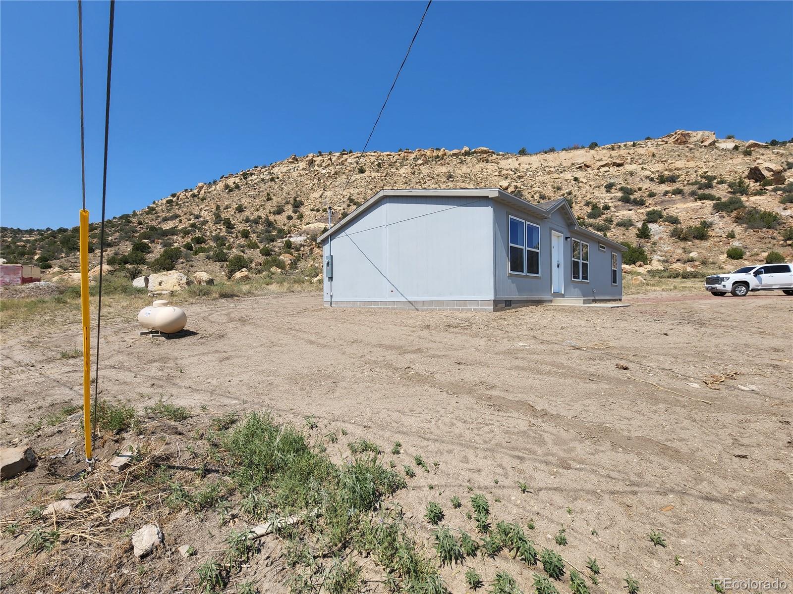 207 Willow Street Rockvale, CO 81244 - Photo 4 of 19 a view of a backyard of a house