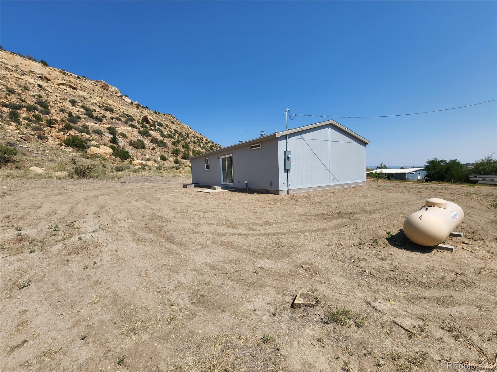 207 Willow Street Rockvale, CO 81244 - Photo 5 of 19 a view of a backyard of a house