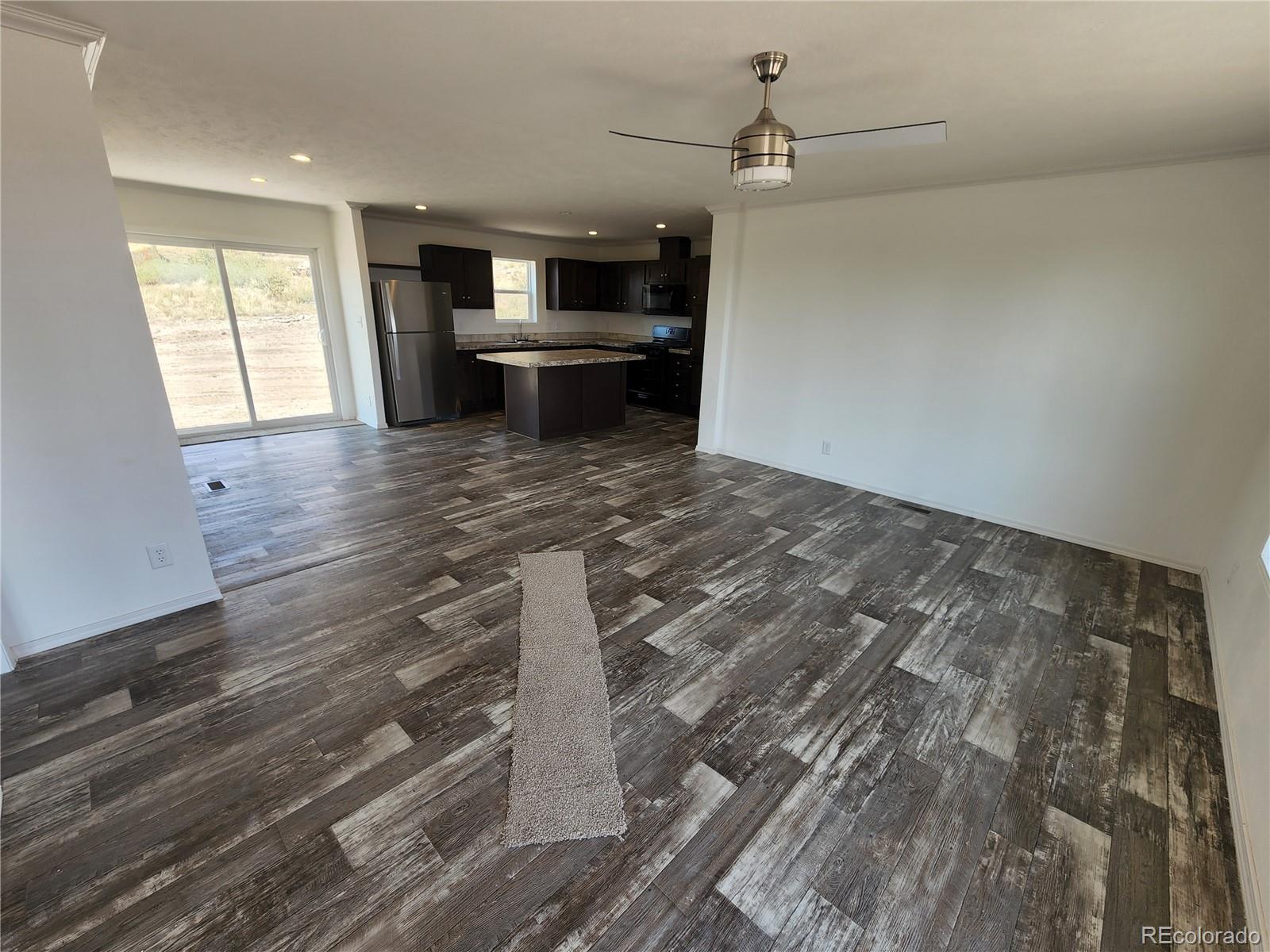 207 Willow Street Rockvale, CO 81244 - Photo 6 of 19 a view of kitchen cabinets and wooden floor