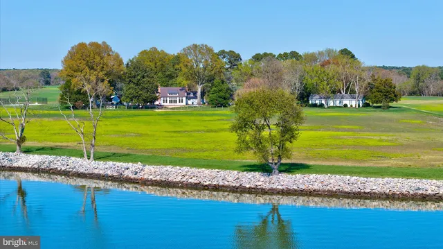 a front view of a house with a yard and a garden