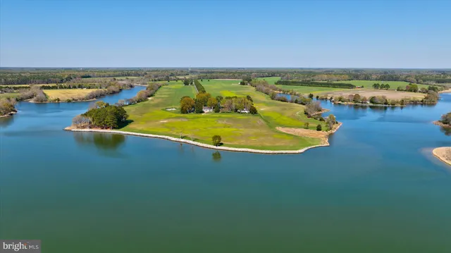 an aerial view of a house with a yard and garden