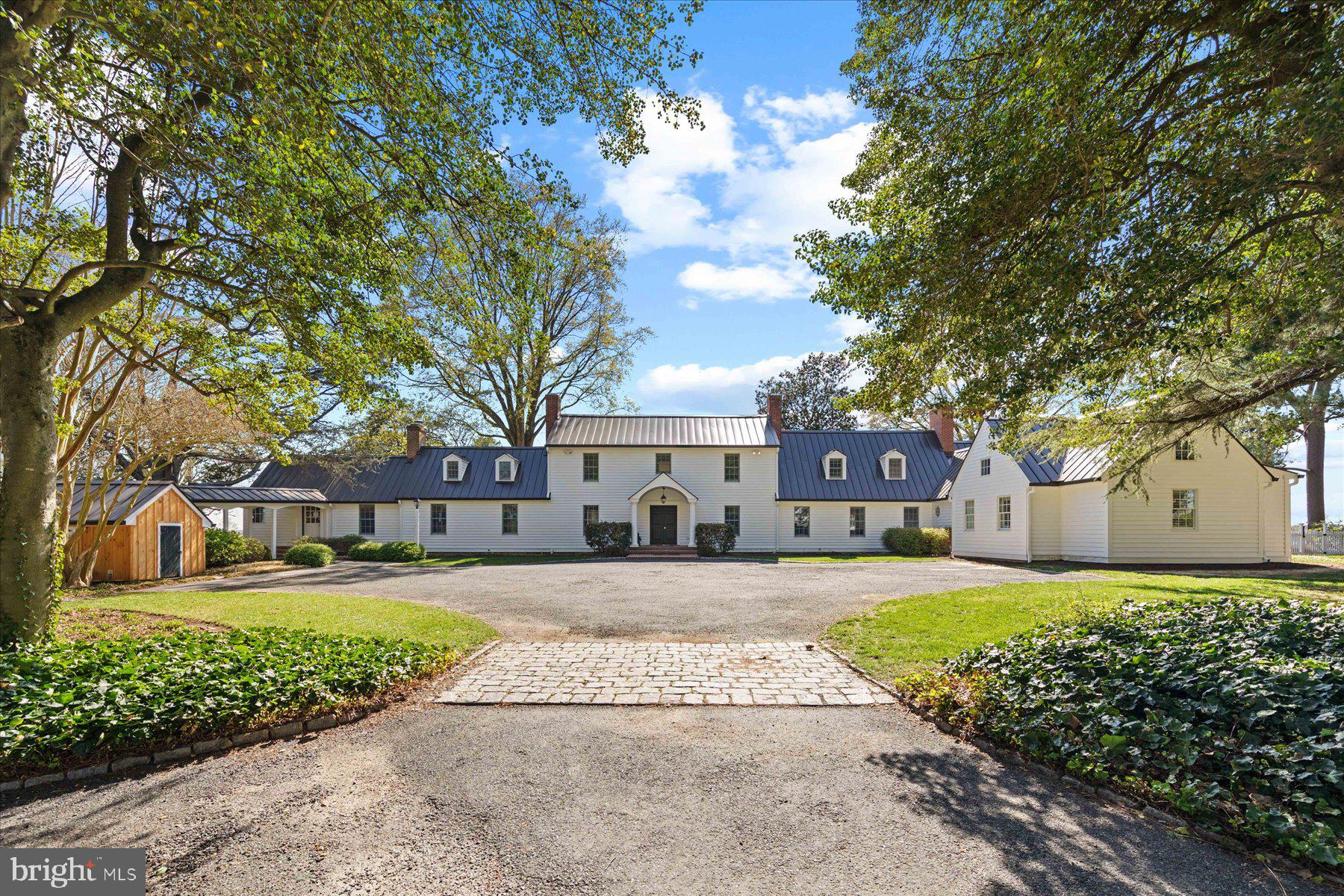 29031 Howell Point Road Trappe, MD 21673 - Photo 25 of 129 a front view of a house with a yard and a garden